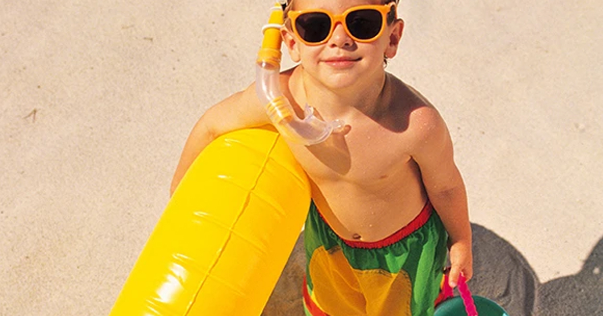 a person wearing a hat and sunglasses posing for the camera